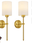 Pair of gold wall sconces with white lampshades and a remote control on a white background.