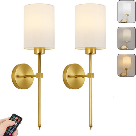 Pair of gold wall sconces with white lampshades and a remote control on a white background.