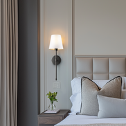 Gold sconces in a bedroom